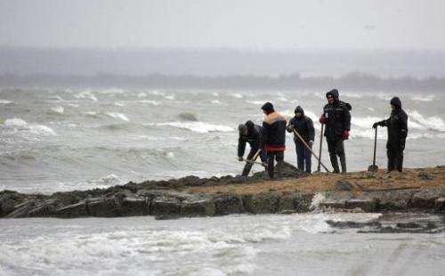 Russian Emergency Ministry personnel clean a section of the Black Sea shore in Tuzla Spit November 13, 2007
