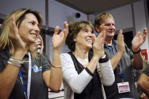 -Scientists celebrate at the French space agency Centre National d'Etudes Spatiales (CNES) in Toulouse, France, on November 12, 