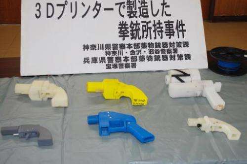 Seized guns made with a 3-D printer are displayed at a police station in Yokohama on May 8, 2014