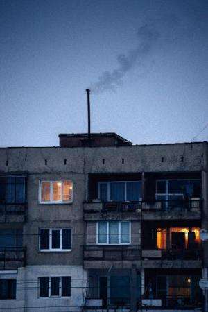 Smoke rises from the chimney of an apartment building in Pernik on January 28, 2014