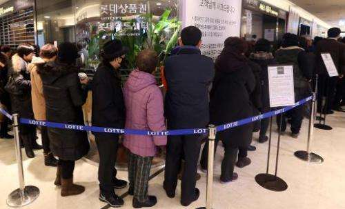 South Korean customers wait to reissue their credit cards at a branch of Lotte Card in Seoul on January 21, 2014
