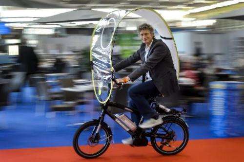 Swiss inventor Rene Wuttig presents a foldable protection against rain and bad weather for bicycles and e-bikes, during the open