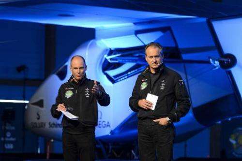 Swiss pilots Bertrand Piccard (L) and Andre Borschberg, who flew the Solar Impulse experimental solar-powered plane on a transco
