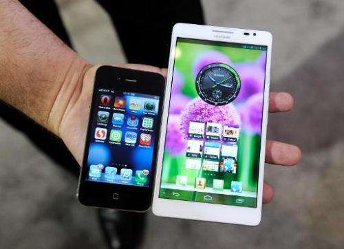 The Huawei Ascend Mate ''phablet'' (R) is on display next to an Apple iPhone at the 2013 International CES on January 9, 2013 in