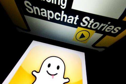 The logo and a page of mobile app &quot;Snapchat&quot; are displayed on tablets on January 2, 2014 in Paris