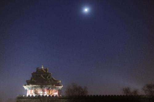 The moon shines over the Turret of Palace Museum at the Forbidden City, in Beijing, on December 13, 2013