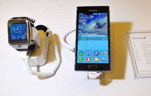 The new Samsung Z910F smartphone (R) and the SM-R380 smartwatch are seen on display at the Tizen Developer Conference in San Fra