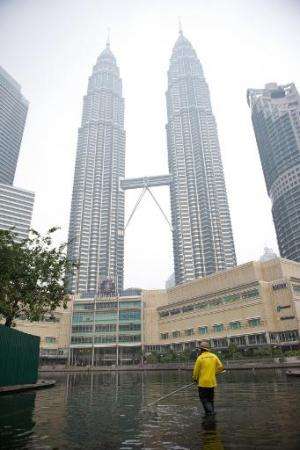 The Petronas Twin Towers are shrouded by haze in Kuala Lumpur on March 4, 2014