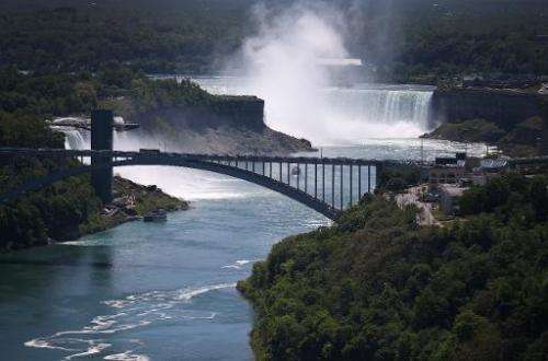 The Rainbow Bridge is seen crossing from the US (L) into Canada, near the Niagara Falls, on June 4, 2013