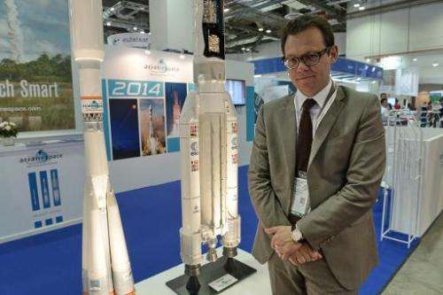 This photograph taken on June 16, 2014 shows Stephane Israel, chief exceutive of Arianespace, posing in front their booth at the