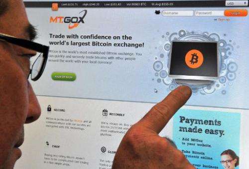 This photo illustration shows a man looking at the bitcoin exchange website of MtGox in Tokyo on February 25, 2014