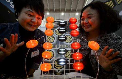 Two Taiwanese exhibitors present their creation during the opening day of the International Exhibition of Inventions of Geneva, 