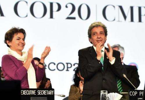 UNFCCC Executive Secretary Christiana Figueres and COP20 President and Peruvian Minister of Environment Manuel Pulgar celebrate 