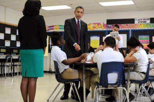 US President Barack Obama (C) visits a classroom at Buck Lodge Middle School in Adelphi, Maryland, on February 4, 2014