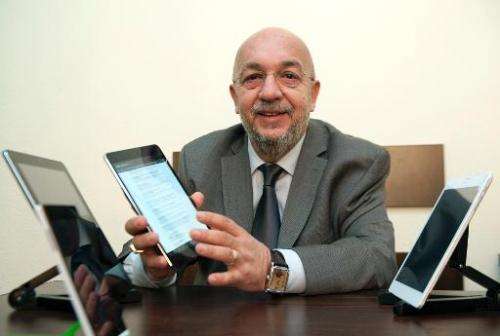 Vahan Chakarian, president of the joint Armenian-US company Minno, shows Armenia's first tablet computer, ArmTab, designed by hi