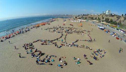 View of an indigenous symbol formed by dozens of activists at a beachfront in Lima, on December 6, 2014, on the sidelines of the