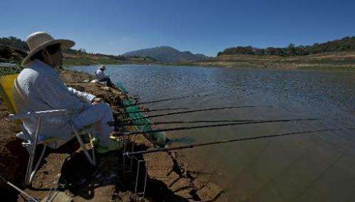 View of fishermen in the Jaguari dam during a drought affecting Sao Paulo state, on August 19, 2014