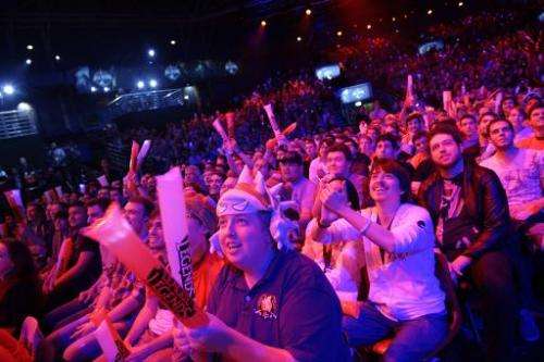 Visitors cheer for international teams during the tournament of the computer game &quot;League of Legends&quot; on May 8, 2014 i
