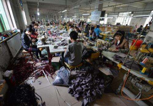 Workers at a handbag factory completing orders to be sold through the Chinese internet e-commerce site Taobao in Baigou, Hebei P