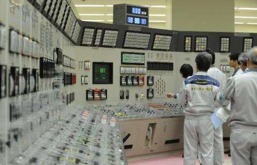 Workers make preparations inside the control room to restart the Monju Prototype Fast Breeder Reactor, in Tsuruga, Fukui prefect