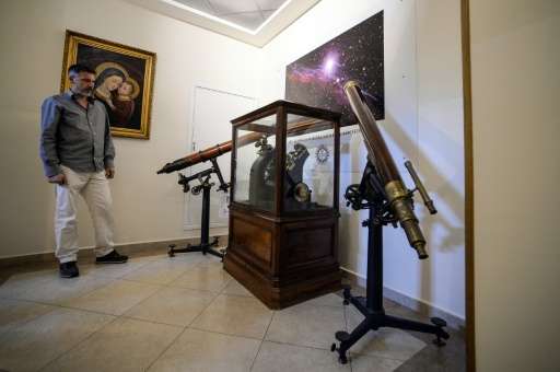 A man looks at an astronomical telescope at the Vatican Astronomical Observatory, or &quot;Specola Vaticana&quot;, in Albano Laz