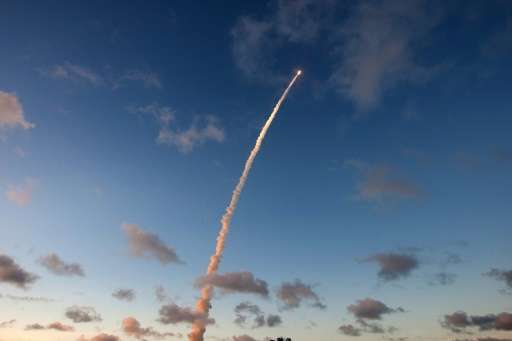 An Ariane-5 rocket is seen blasting off from the European space centre at Kourou, French Guiana, as it delivers two telecommunic