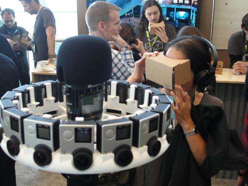 An attendee at Google's annual developers conference checks out cardboard virtual reality head gear, May 28, 2015 in San Francis
