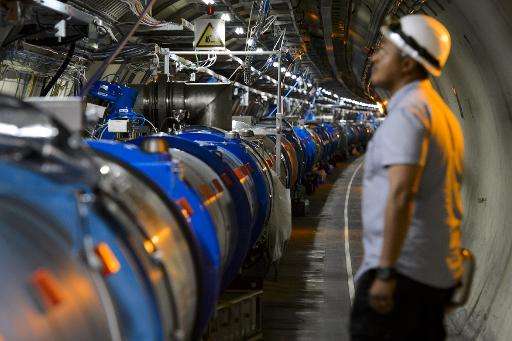A scientist looks at a section of the Large Hadron Collider (LHC) which was used to prove the existence of the Higgs Boson—also 