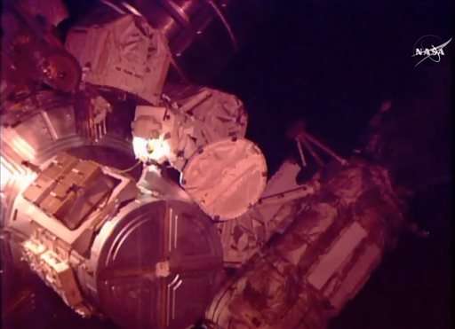 Astronauts help move stalled rail car during spacewalk