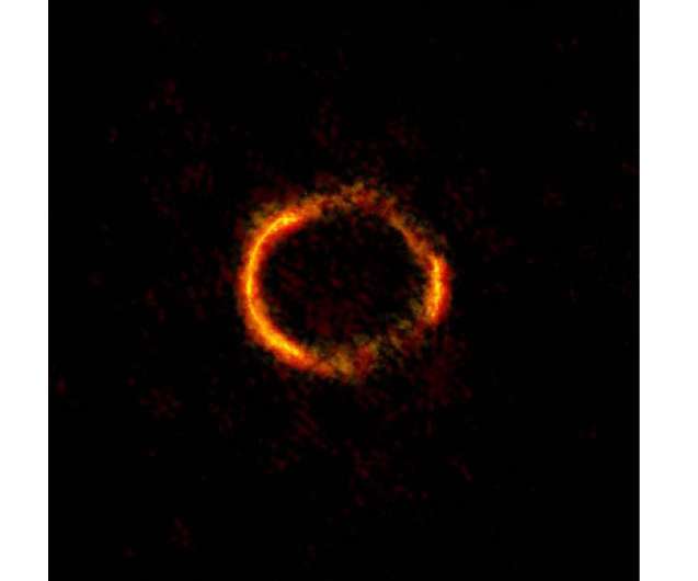 Astronomers "weigh" a galaxy's black hole by studying the einstein ring phenomenon