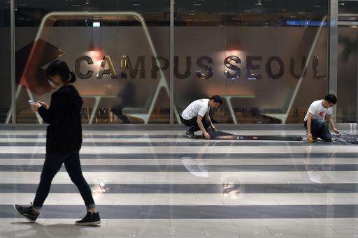 A woman walks past Google's first Asian start-up &quot;campus&quot; in Seoul on May 8, 2015