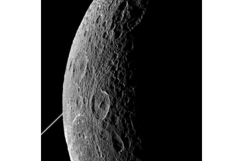 Cassini zooms past Dione