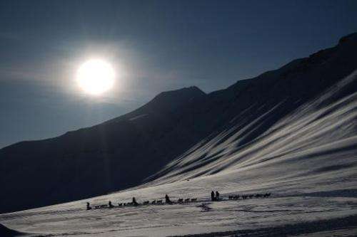 Eclipse watching tourists ride dog sleds outside of Longyearbyen, Svalbard, an archipeligo administered by Norway ahead of the M