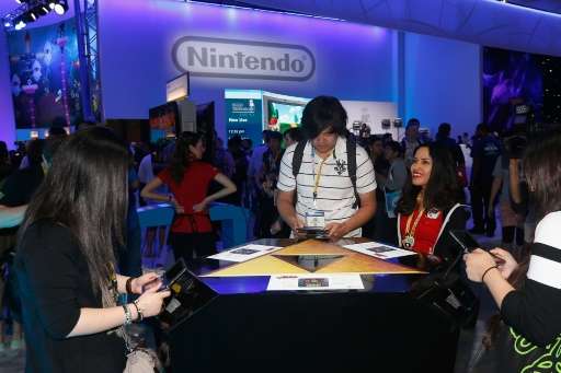 Game enthusiasts test new game titles at the Nintendo exhibit, during the Annual Gaming Industry Conference E3 at the Los Angele