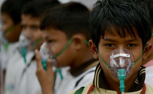Indian schoolchildren wear facemasks to spread awareness of the problem of air pollution in New Delhi, after the World Health Or