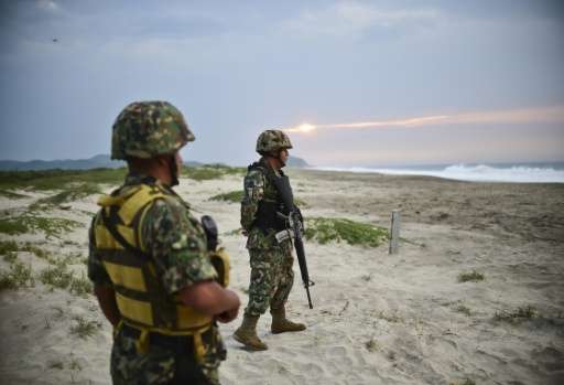 Mexican marines protect the eggs of Golfina turtles from thieves at Morro Ayuta Beach, Oaxaca State, Mexico, on September 10, 20