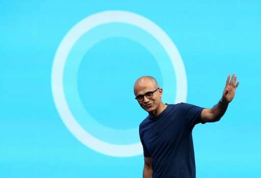 Microsoft CEO Satya Nadella walks in front of the new Cortana logo during the 2014 Microsoft Build developer conference on April