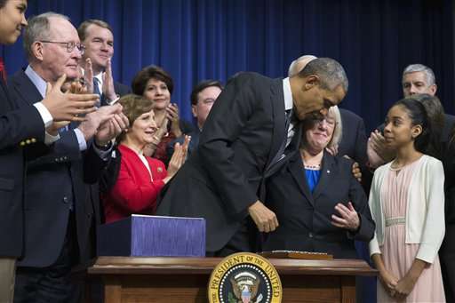 Obama signs education law rewrite shifting power to states