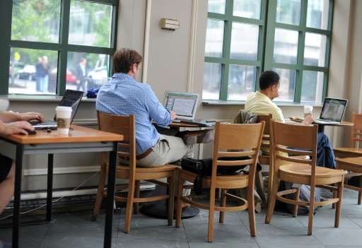 People use their laptop computers at a coffee shop in Washington, DC on May 9, 2012
