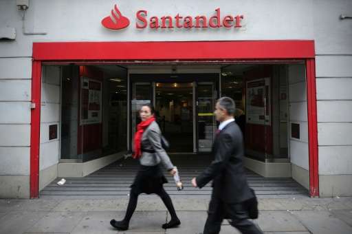 People walk past a branch of Santander in central London