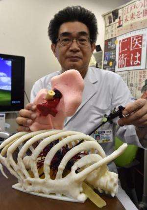 Professor Toshiaki Morikawa holds a 3D-printed lung at the Jikei University hospital in Tokyo