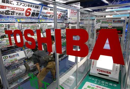 Scandal-hit Toshiba cuts jobs, sells plant, projects red ink