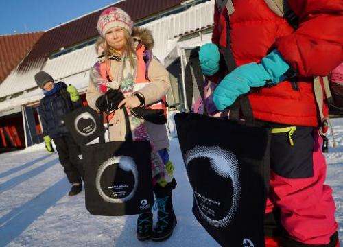 School children show off eclipse bags they bought at the Svalbard Museum on March 19, 2015 ahead of the March 20 total solar ecl