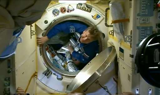 This March 28, 2015 still image from NASA TV shows Russian cosmonaut Gennady Padalka entering the International Space Station