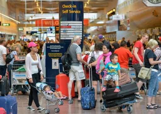 Travellers wait in the terminal building at Stockholm's Arlanda on August 17, 2013