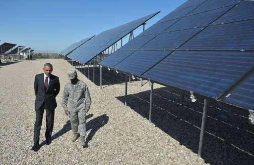 US President Barack Obama speaks with Commander Col Ronald Jolly as he tours a solar array at Hill Air Force Base in Utah