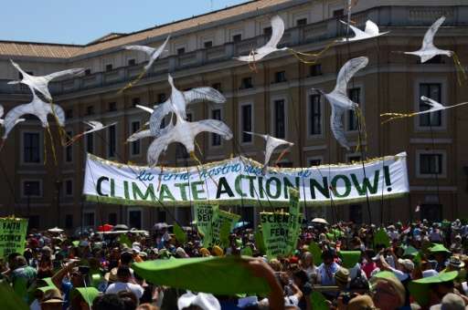 Environmental activists display a banner calling for action on climate change as they arrive on St. Peter's square prior to Pope