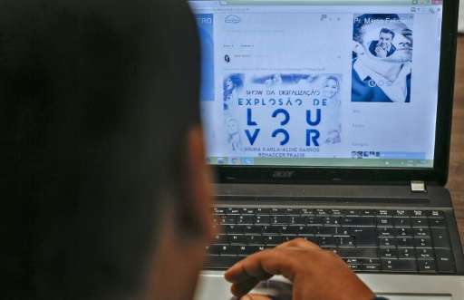 A man looks at his profile on the social network for evangelicals Facegloria, in Sao Paulo, Brazil