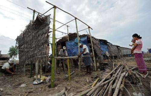 File picture shows a Myanmar family repairing their home in the aftermath of cyclone Nargis which smashed through the southern d