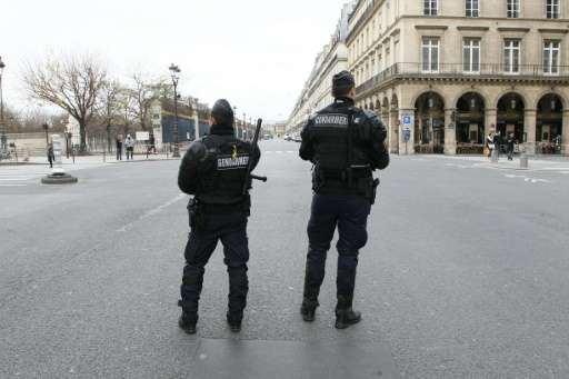 French police stand guard on November 30, 2015 on Rue de Rivoli in Paris, closed to traffic due to the COP21 Climate change conf